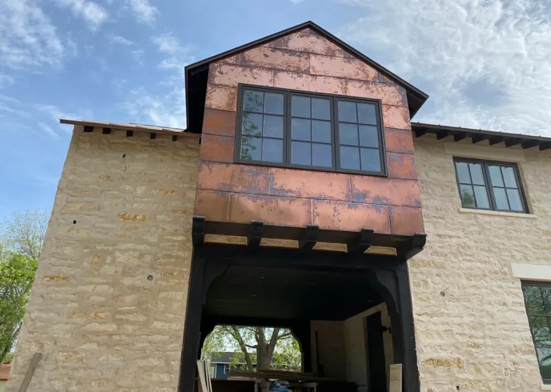 Copper metal panel facade on a stone building for Skylight Installation in Pine Hills
