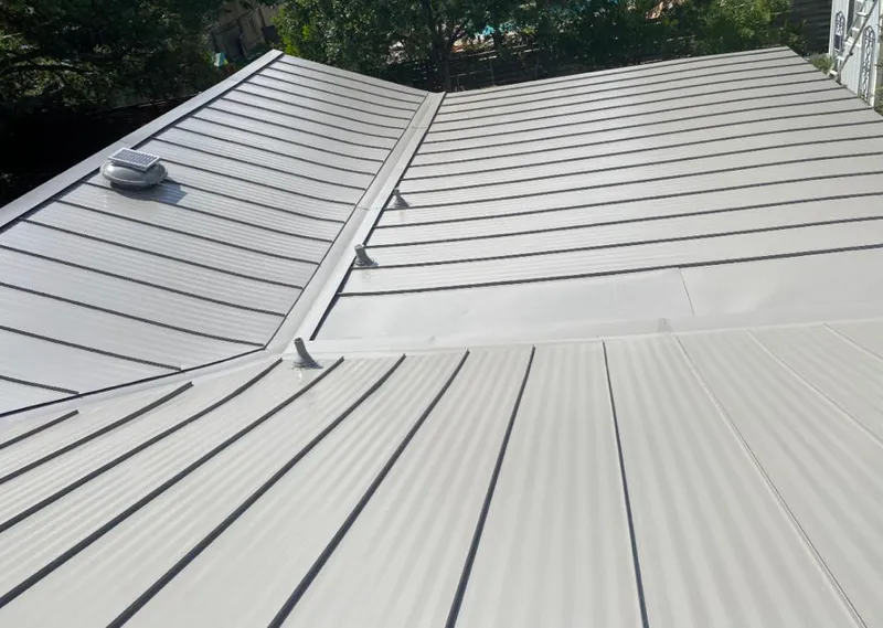 Solar attic fan installed on a metal roof for Roof Ventilation in Pine Hills